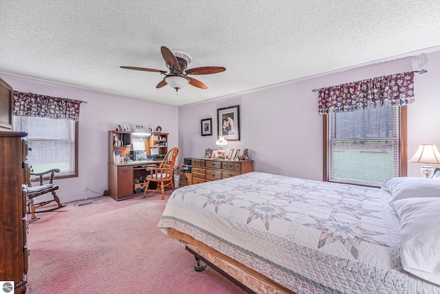 carpeted bedroom featuring a textured ceiling and ceiling fan