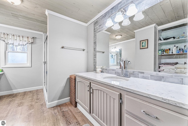 full bathroom featuring vanity, ornamental molding, wood finished floors, baseboards, and wood ceiling