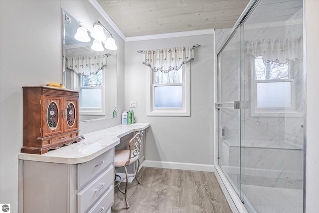 bathroom featuring ornamental molding, a shower stall, a wealth of natural light, and vanity