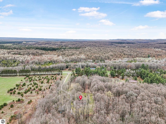 drone / aerial view featuring a forest view