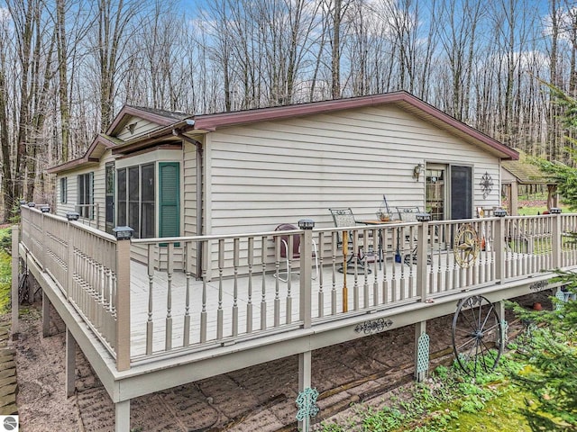 rear view of property with a wooden deck