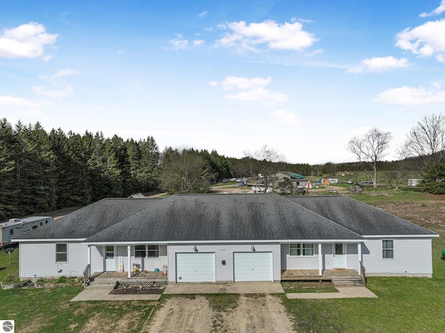 7276 Tiger Dr Unit A, And B, Lake Ann, MI 49650 - ranch-style house featuring a porch, a garage, a front lawn, and driveway