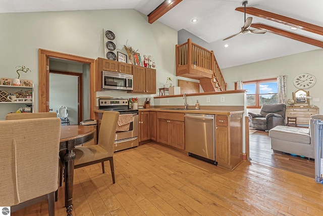 7276 Tiger Dr Unit A, And B, Lake Ann, MI 49650 - kitchen with ceiling fan, appliances with stainless steel finishes, a sink, beam ceiling, and open floor plan