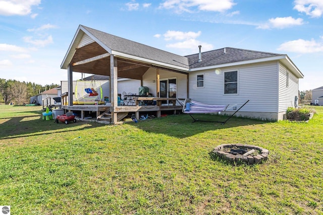 7276 Tiger Dr Unit A, And B, Lake Ann, MI 49650 - rear view of property with a wooden deck, a yard, and an outdoor fire pit