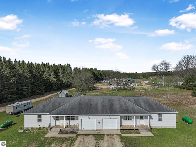 7276 Tiger Dr Unit A, And B, Lake Ann, MI 49650 - exterior space with a garage, dirt driveway, a yard, and a porch