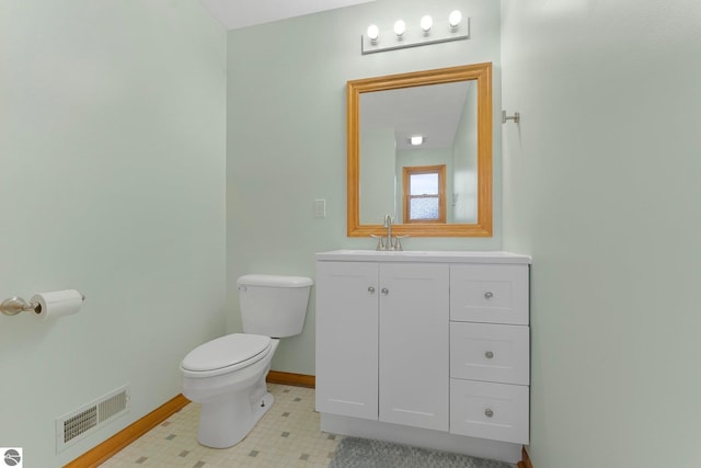 7276 Tiger Dr Unit A, And B, Lake Ann, MI 49650 - bathroom featuring baseboards, vanity, toilet, and visible vents
