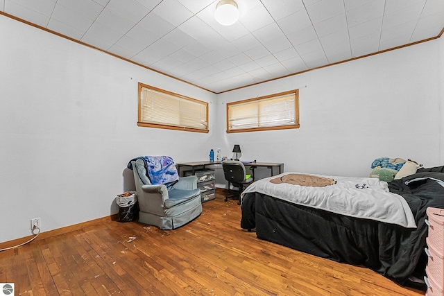1981 S Lake Mitchell Dr, Cadillac, MI 49601 - bedroom with wood-type flooring and ornamental molding