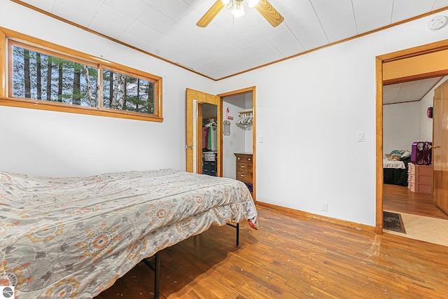 1981 S Lake Mitchell Dr, Cadillac, MI 49601 - bedroom featuring visible vents, ornamental molding, ceiling fan, and hardwood / wood-style floors
