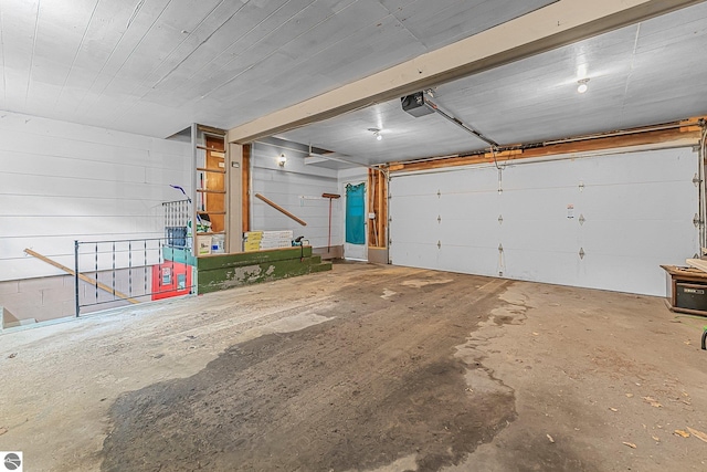 1981 S Lake Mitchell Dr, Cadillac, MI 49601 - garage featuring a garage door opener