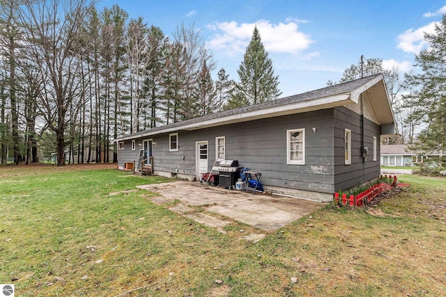 1981 S Lake Mitchell Dr, Cadillac, MI 49601 - back of house featuring a patio and a yard