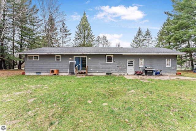 1981 S Lake Mitchell Dr, Cadillac, MI 49601 - rear view of property featuring a yard, a patio, and entry steps