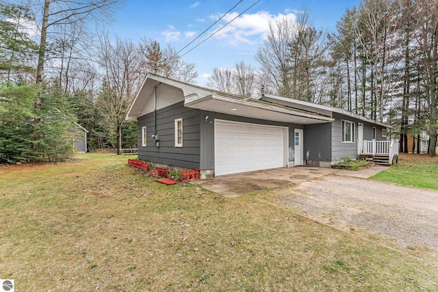 1981 S Lake Mitchell Dr, Cadillac, MI 49601 - view of home's exterior featuring a garage, a yard, and concrete driveway