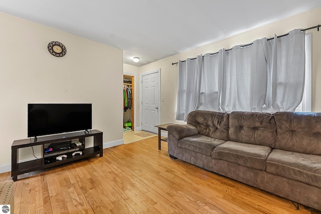 1981 S Lake Mitchell Dr, Cadillac, MI 49601 - living room featuring baseboards and wood finished floors