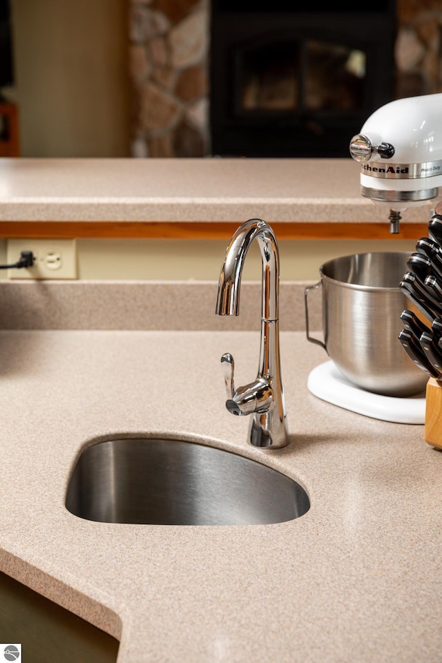 interior details with a sink and light countertops