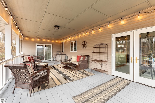 wooden terrace featuring an outdoor living space and french doors