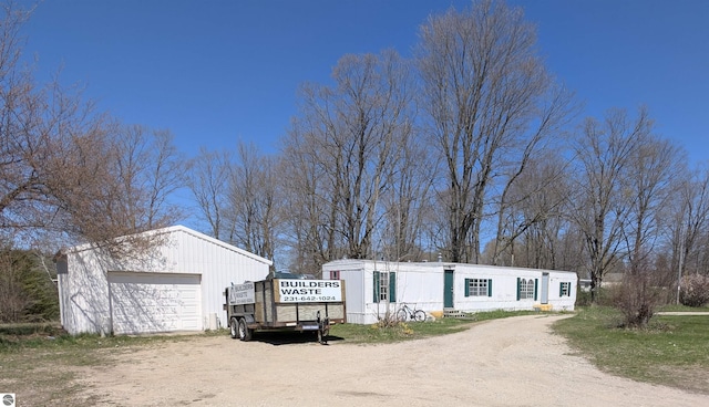 view of front of home with an outbuilding, driveway, and a detached garage