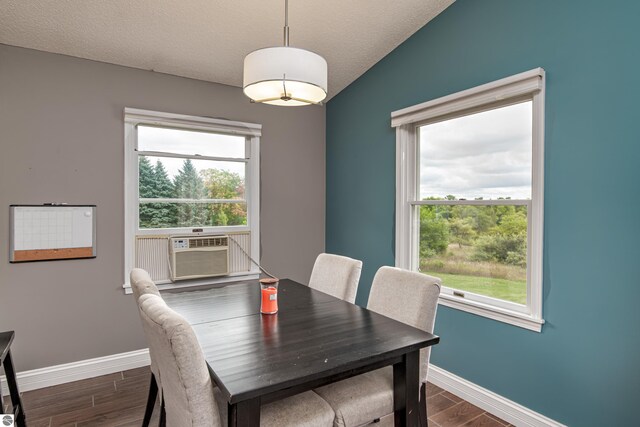 4215 Hearthside Dr, Traverse City, MI 49684 - dining space with a wealth of natural light, dark wood finished floors, and baseboards