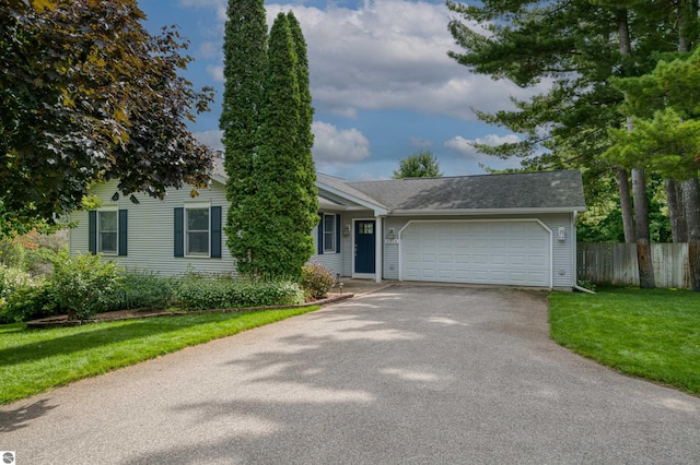 4215 Hearthside Dr, Traverse City, MI 49684 - ranch-style home with fence, an attached garage, driveway, and a front yard