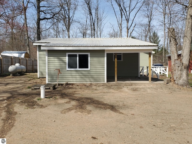 view of outbuilding featuring fence