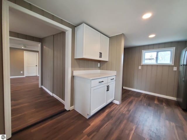 kitchen with light countertops, baseboards, and dark wood-type flooring