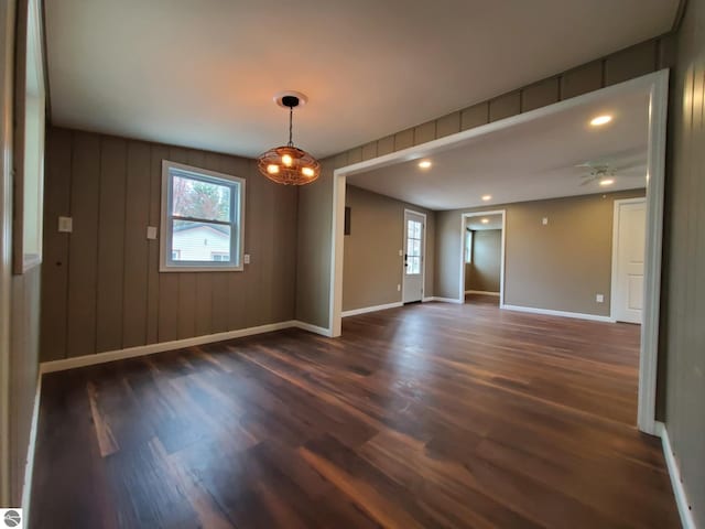 unfurnished room with a healthy amount of sunlight and dark wood finished floors