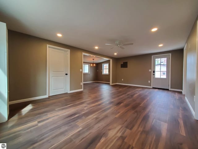 empty room featuring recessed lighting, a ceiling fan, plenty of natural light, and dark wood finished floors