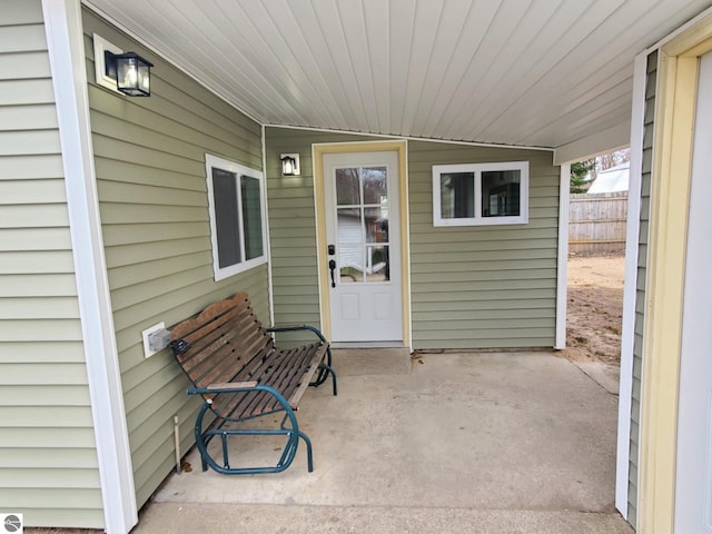 entrance to property with a patio area and fence