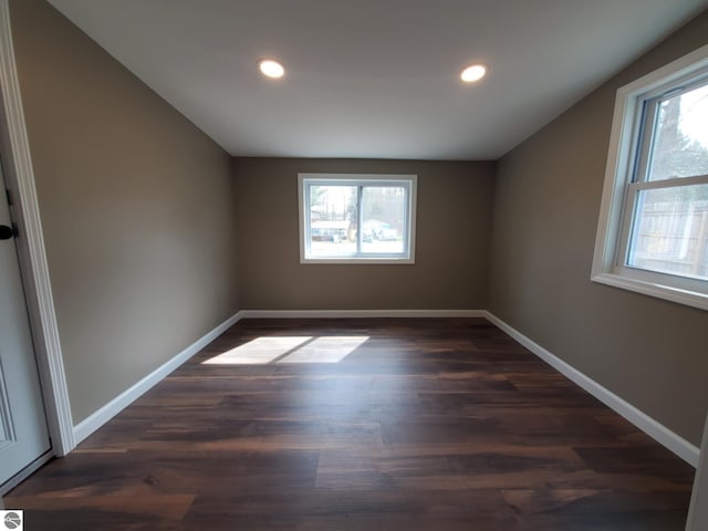bonus room with dark wood finished floors, baseboards, and recessed lighting