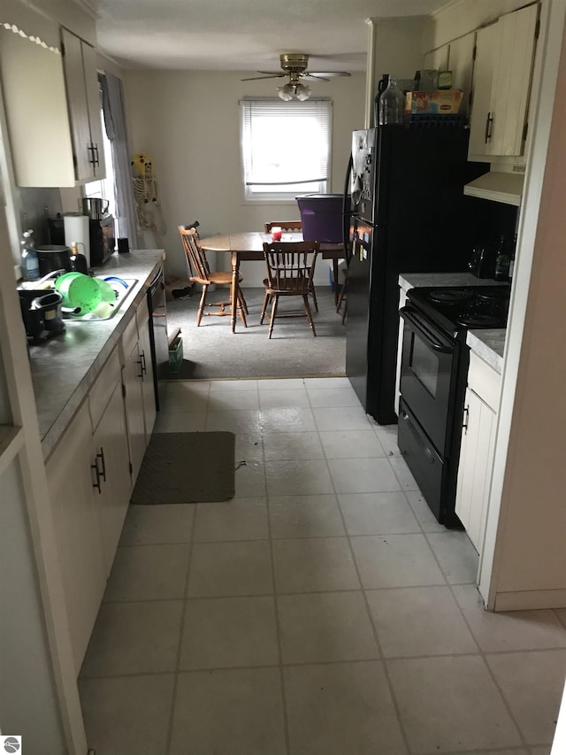 kitchen featuring black appliances, light countertops, ceiling fan, and white cabinetry