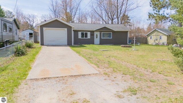 9166 Michigan Ave, Saint Helen, MI 48656 - view of front facade with concrete driveway, a front yard, fence, and a garage