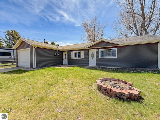 9166 Michigan Ave, Saint Helen, MI 48656 - single story home featuring an outdoor fire pit, an attached garage, a front lawn, and aphalt driveway