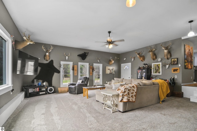 living room featuring carpet and a ceiling fan