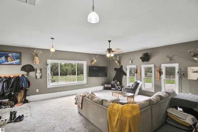 living room featuring a ceiling fan and carpet flooring