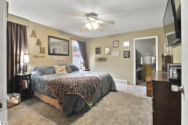 carpeted bedroom featuring ceiling fan and visible vents