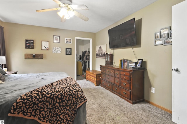 carpeted bedroom featuring baseboards and a ceiling fan