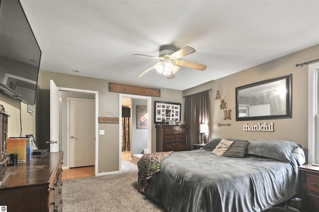 bedroom with light carpet and ceiling fan