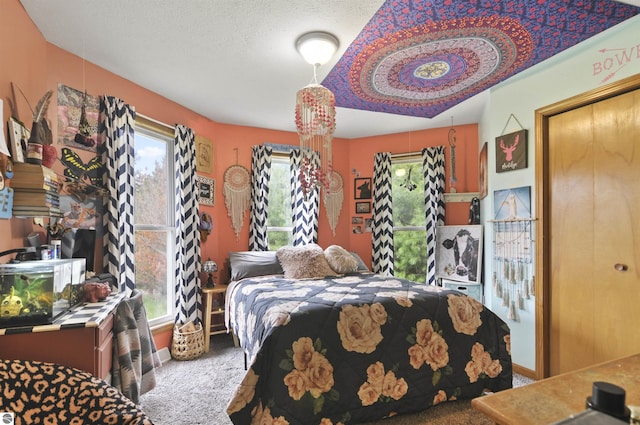 carpeted bedroom featuring a textured ceiling