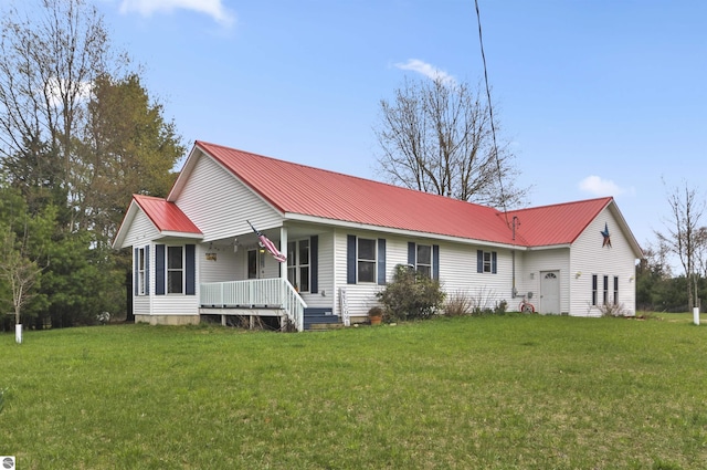 view of front of house featuring a front yard, a porch, and metal roof