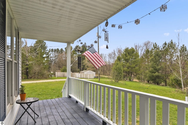wooden deck with a lawn