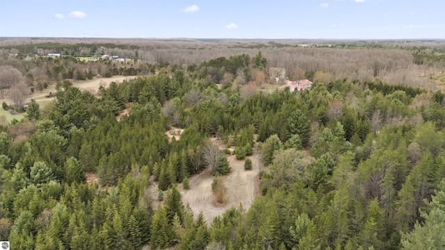 birds eye view of property with a wooded view