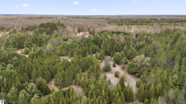 birds eye view of property with a view of trees
