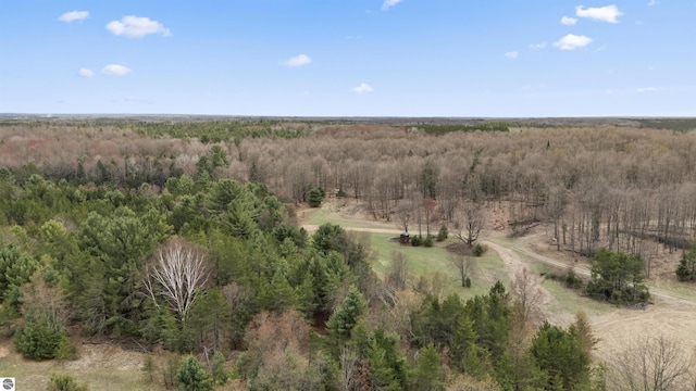birds eye view of property featuring a wooded view