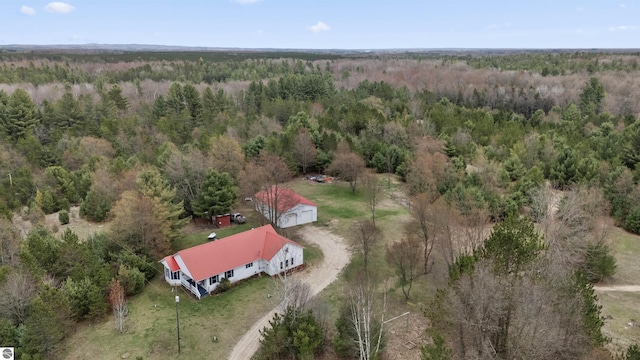 birds eye view of property featuring a view of trees