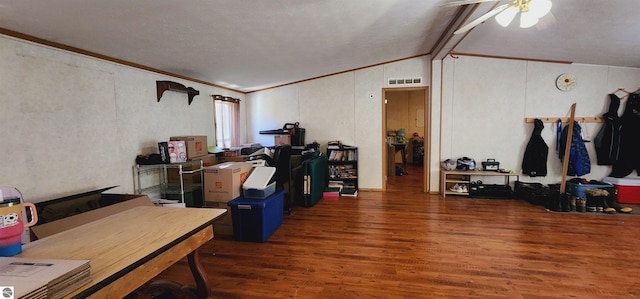 interior space with wood finished floors, ornamental molding, visible vents, ceiling fan, and vaulted ceiling with beams