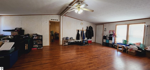 interior space featuring lofted ceiling with beams, wood finished floors, visible vents, crown molding, and a ceiling fan
