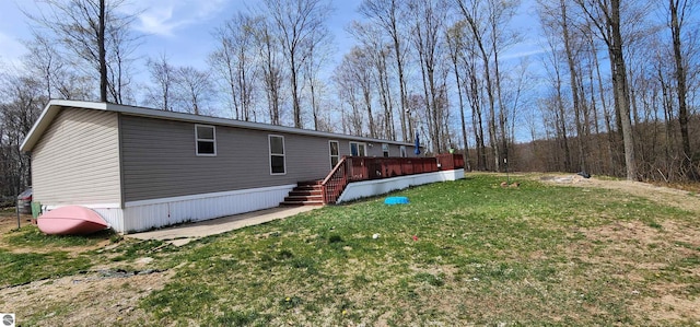 exterior space featuring a yard, a deck, and stairway