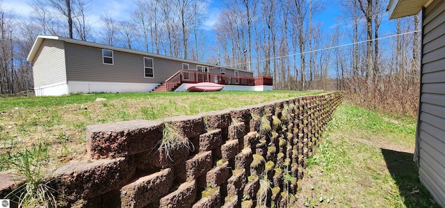 view of yard featuring stairs and a wooden deck