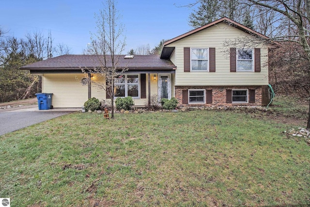 7809 Potter Rd, Bear Lake, MI 49614 - split level home with driveway, brick siding, and a front yard