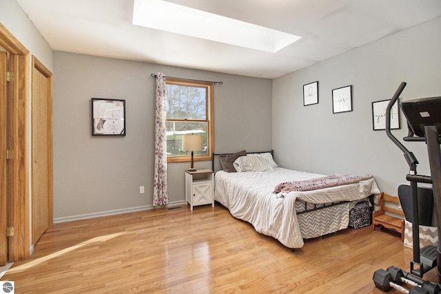 7809 Potter Rd, Bear Lake, MI 49614 - bedroom featuring light wood finished floors, visible vents, baseboards, and a skylight