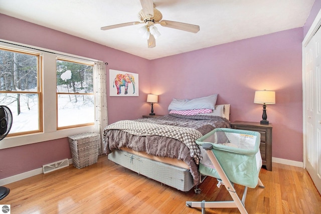 7809 Potter Rd, Bear Lake, MI 49614 - bedroom with wood finished floors, a ceiling fan, a closet, visible vents, and baseboards